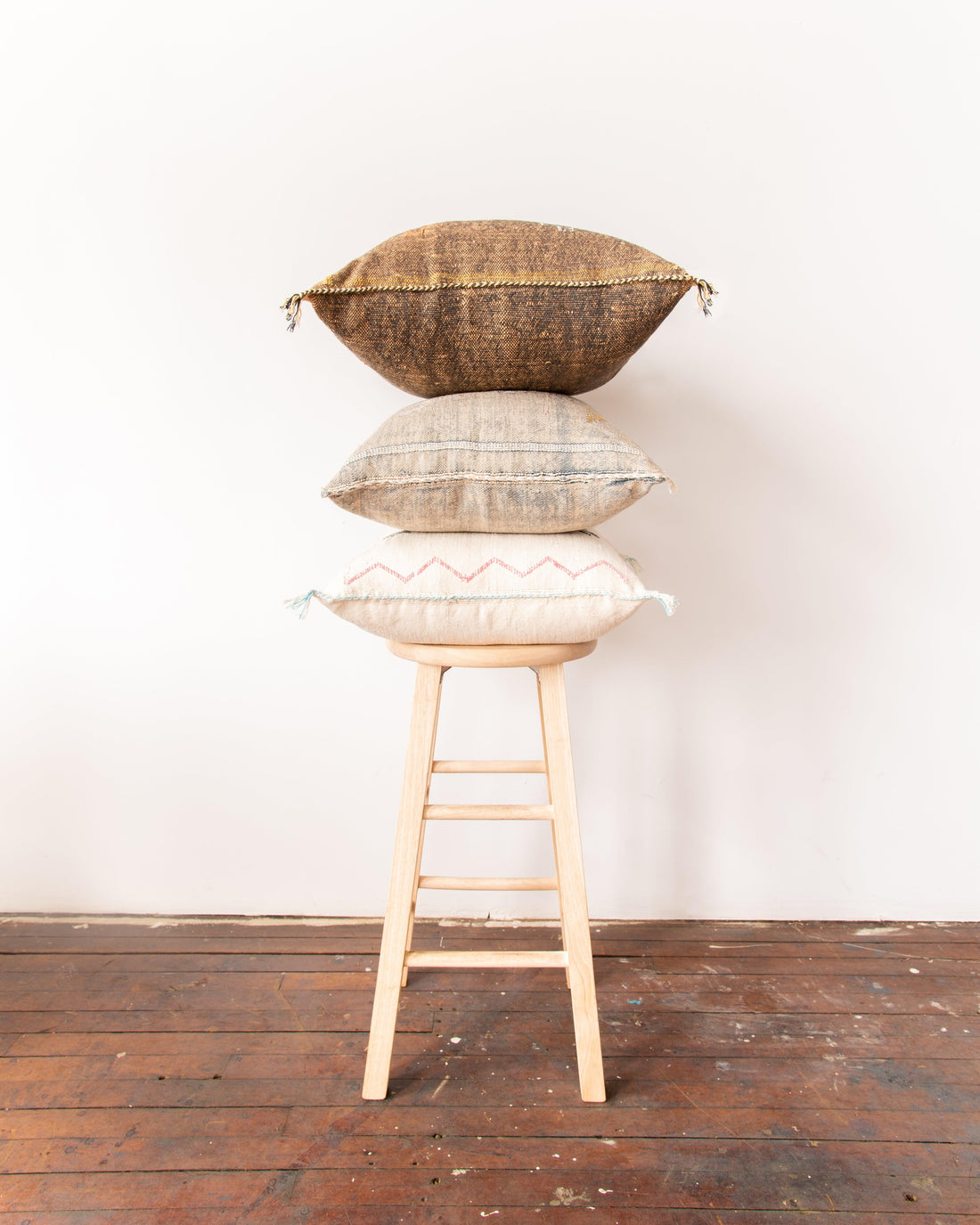 pillows stacked on stool